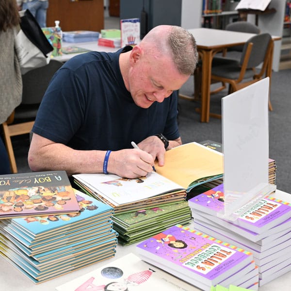 Frank Murphy signing books.