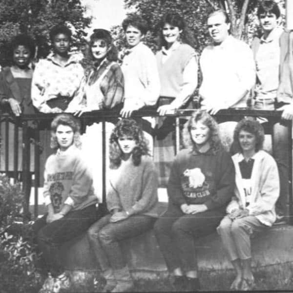 A black-and-white photo showing students on campus during the 1980s.