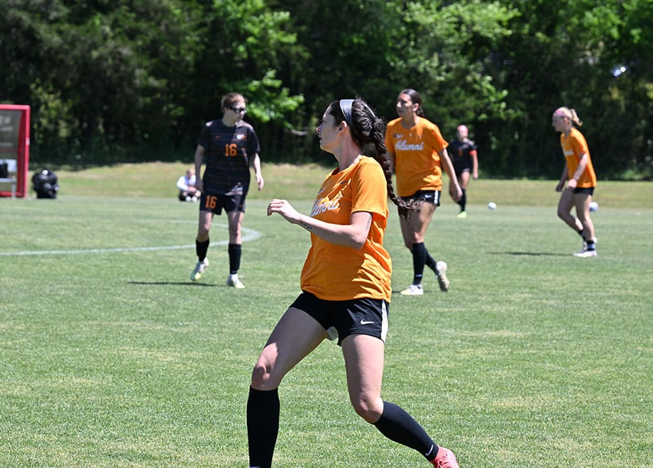 Five women on the soccer field.